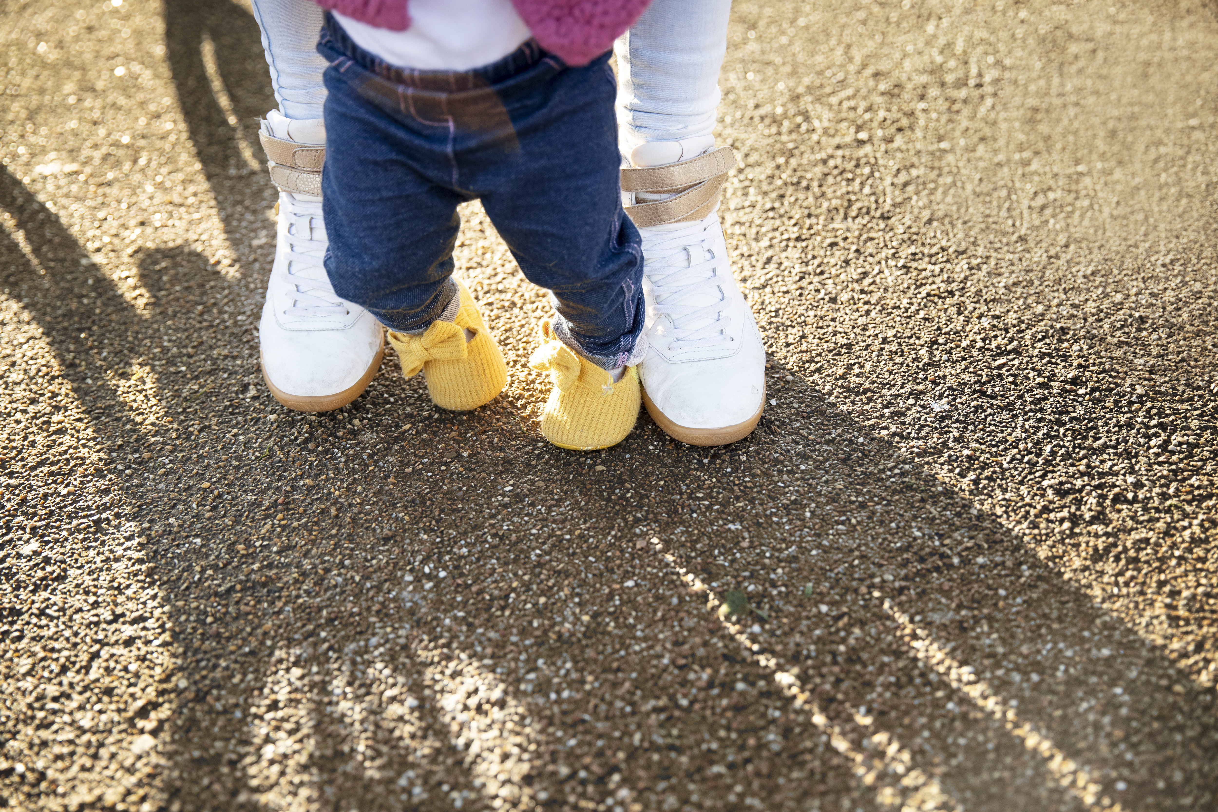 Pais brincando com bebê que está andando